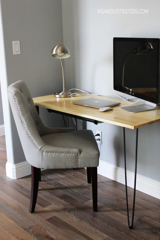 Simple DIY hairpin desk with pencil drawer with monitor and laptop on top.