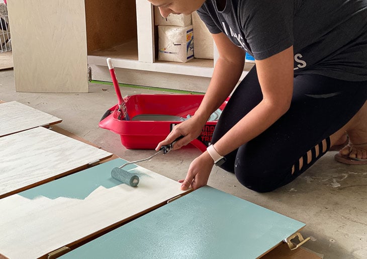 woman painting the veneer cabinet doors