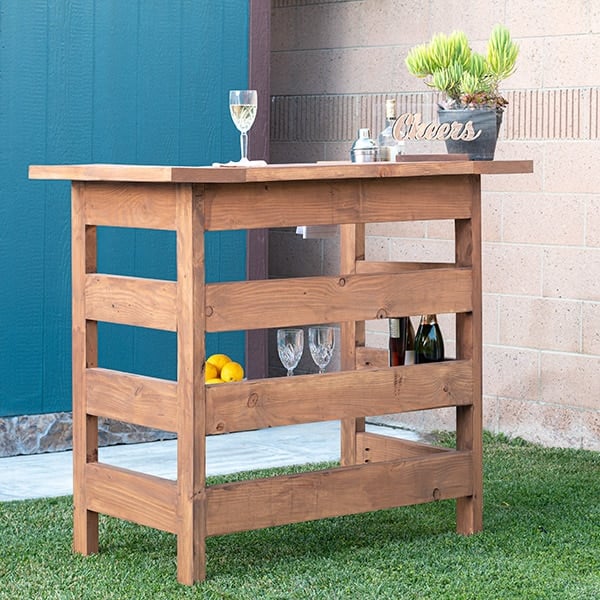 Learn how to build a wooden DIY outdoor bar perfect for any deck, patio or porch with step by step tutorial, plans, and video.