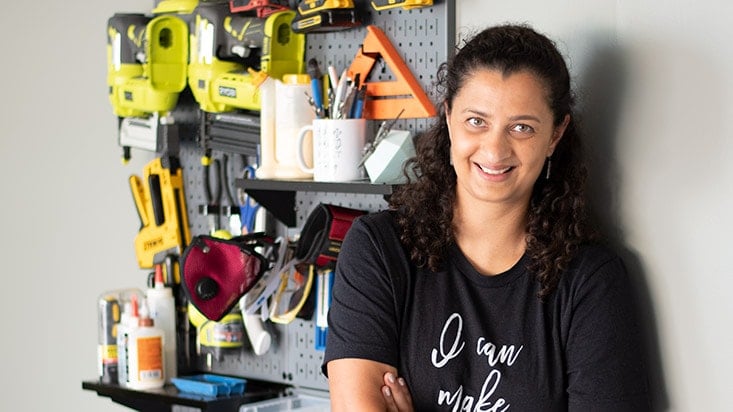 woman standing in front of a tool wall