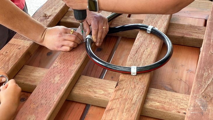 coiling the hose onto the base.