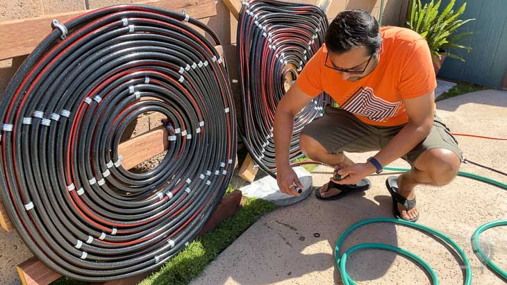 man connecting hoses together