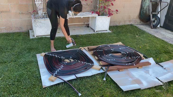 woman spray painting coils black