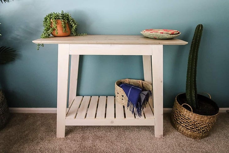 pale pink console table with slatted bottom shelf