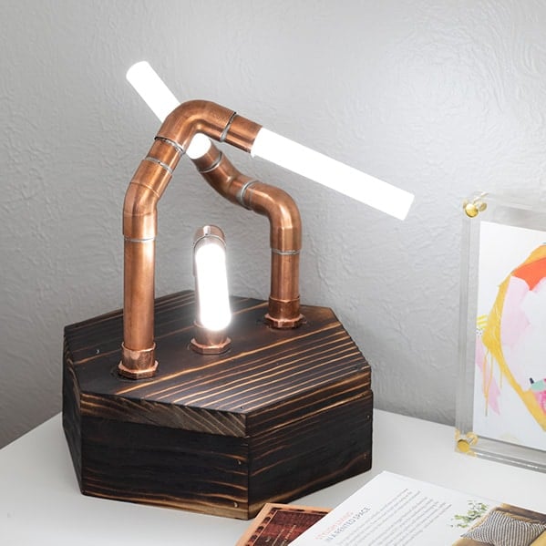 Make a modern industrial DIY copper pipe LED lamp with glowing acrylic rods. Learn all the steps and details you need to know to make this fun project!