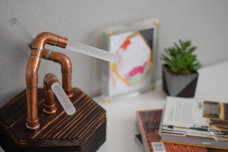 DIY copper pipe and LED lamp on a hexagon base and acrylic rods turn off on a desk