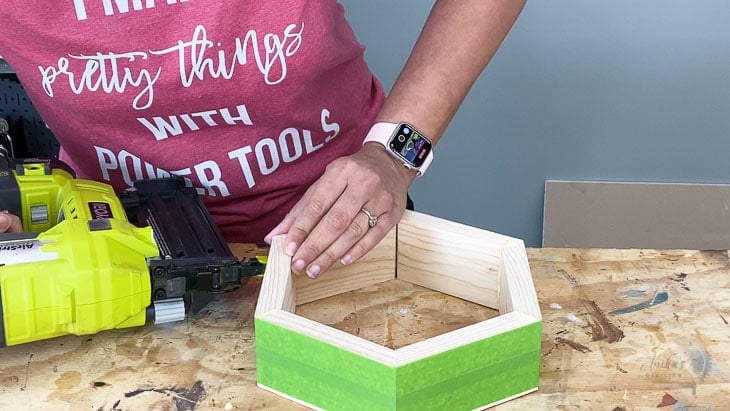 Woman Building a hexagon base out of wood