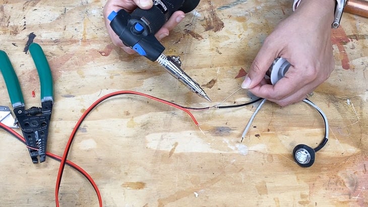 woman soldering wires together using the bernzomatic detail torch