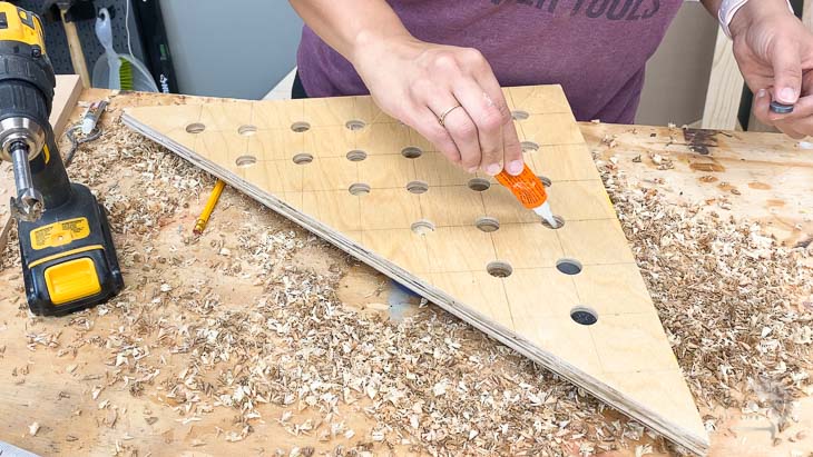 Attaching magnets to the plywood to make a magnetic plywood