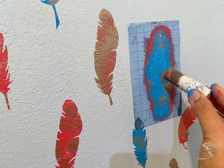 mixing up colors on the stenciled wall pattern