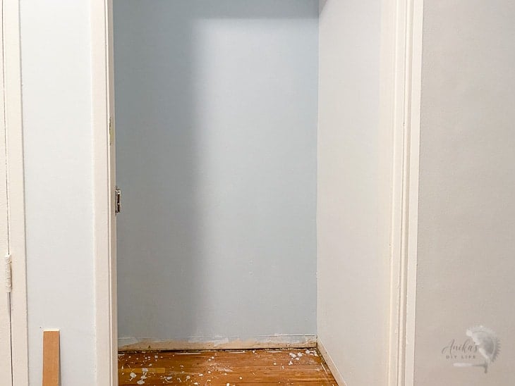 Coat closet repainted with blue and white ready to be stenciled using Cricut made stencils