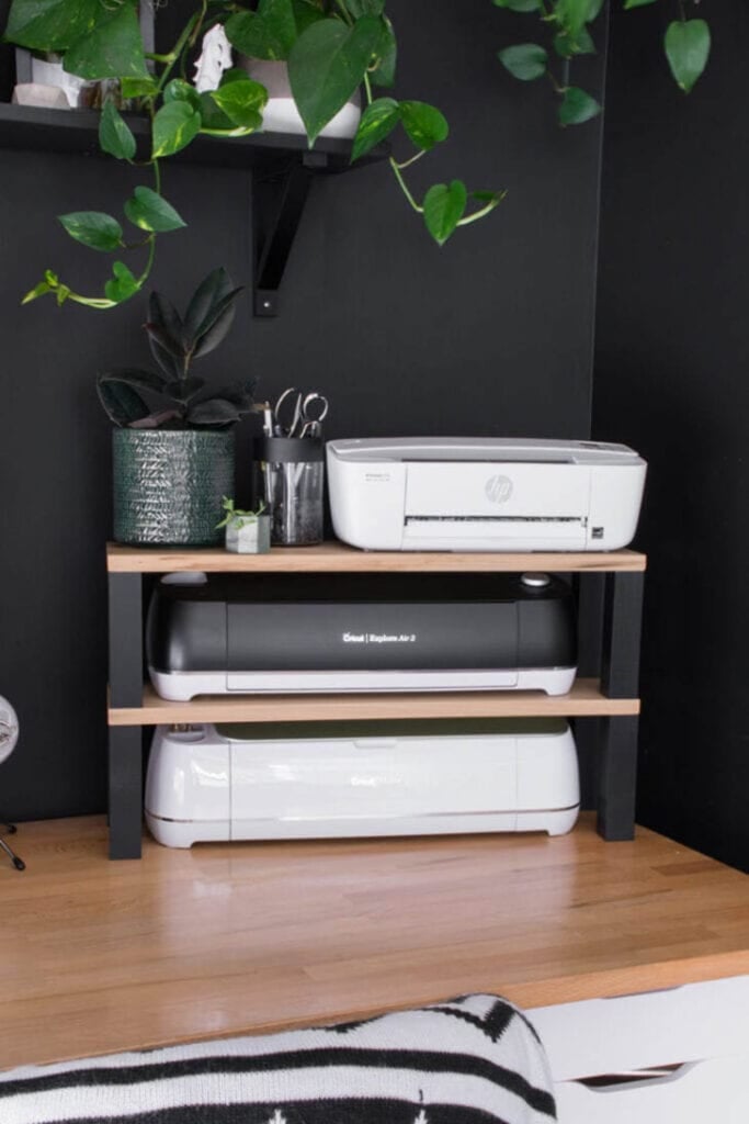 printer stand sitting on desk with Cricut machines on the shelves