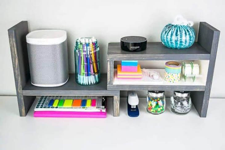 expandable desk top organizer with desk supplies on it