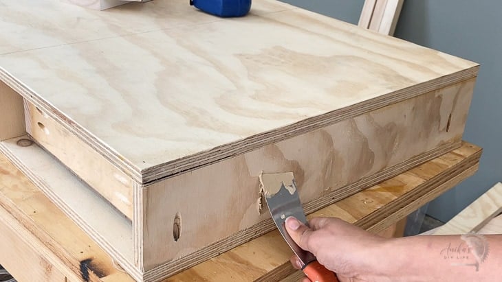 Filling holes in plywood preparing to fill