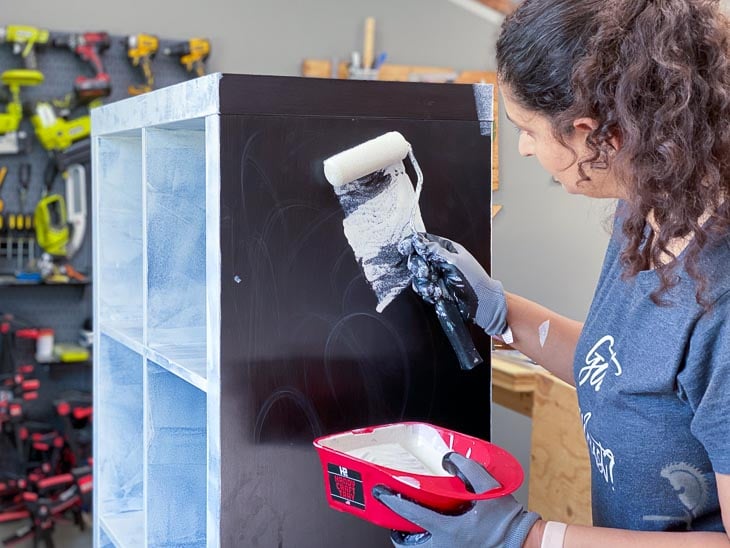 Woman applying primer on the Ikea Kallax shelf