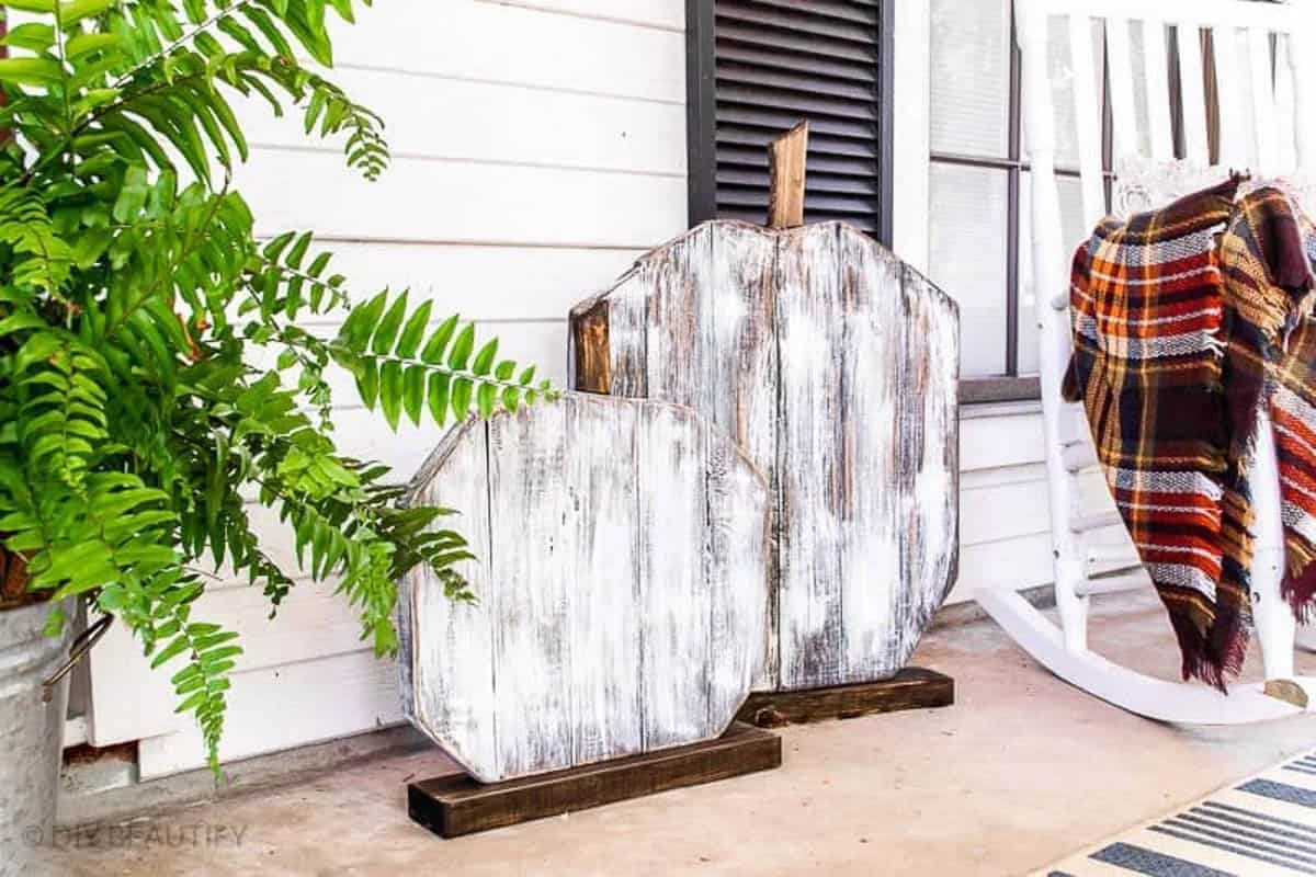 Large wood pumpkins sitting a porch