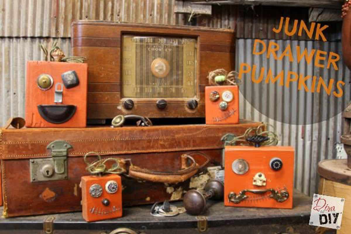 wood pumpkins with faces made out of metal junk