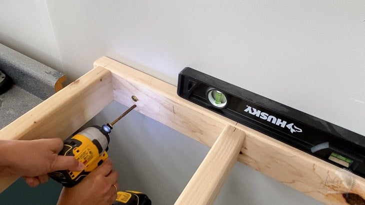 Attaching brace for DIY floating shelf to the wall using strong screws