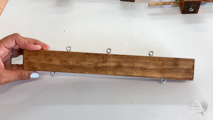 top bar with multiple screw eyes to attach DIY mobile