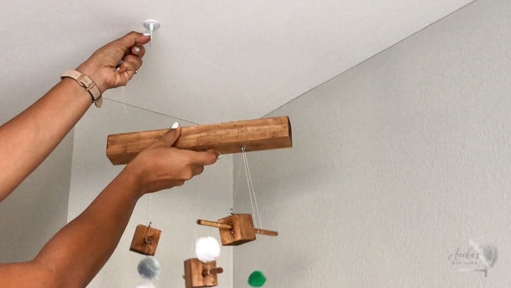 Woman hanging up DIY animal mobile