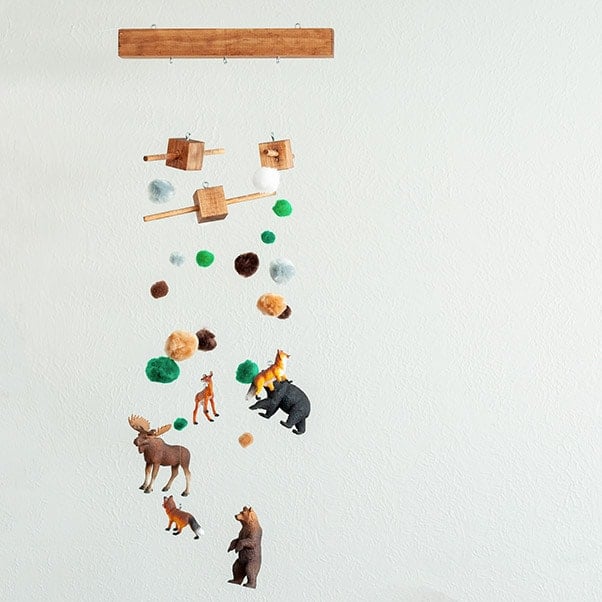 How to make a DIY baby mobile. Step by step tutorial and video for woodland themed nursery decor. #woodworking