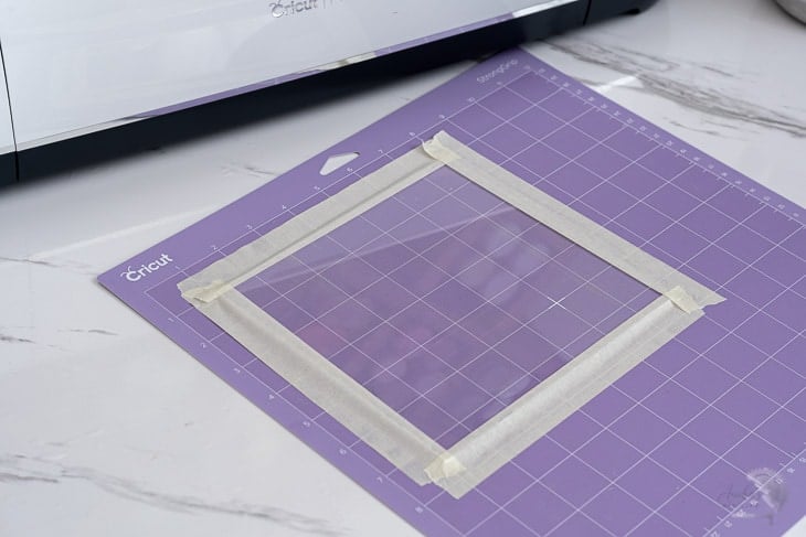 Acrylic sheet loaded on mat with masking tape ready to be engraved with Cricut Maker
