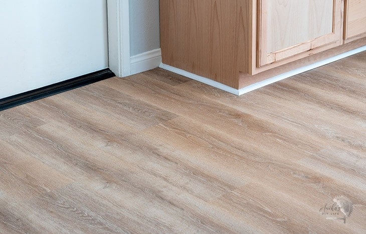 New Lifeproof vinyl plank flooring in kitchen showing how to trim around cabinets