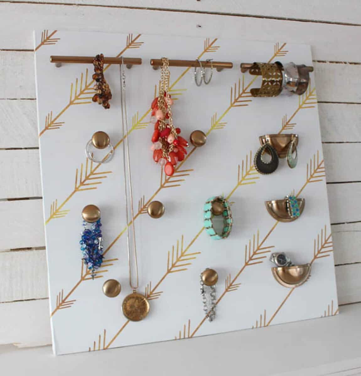 Cabinet hardware on patterned background to hang jewelry
