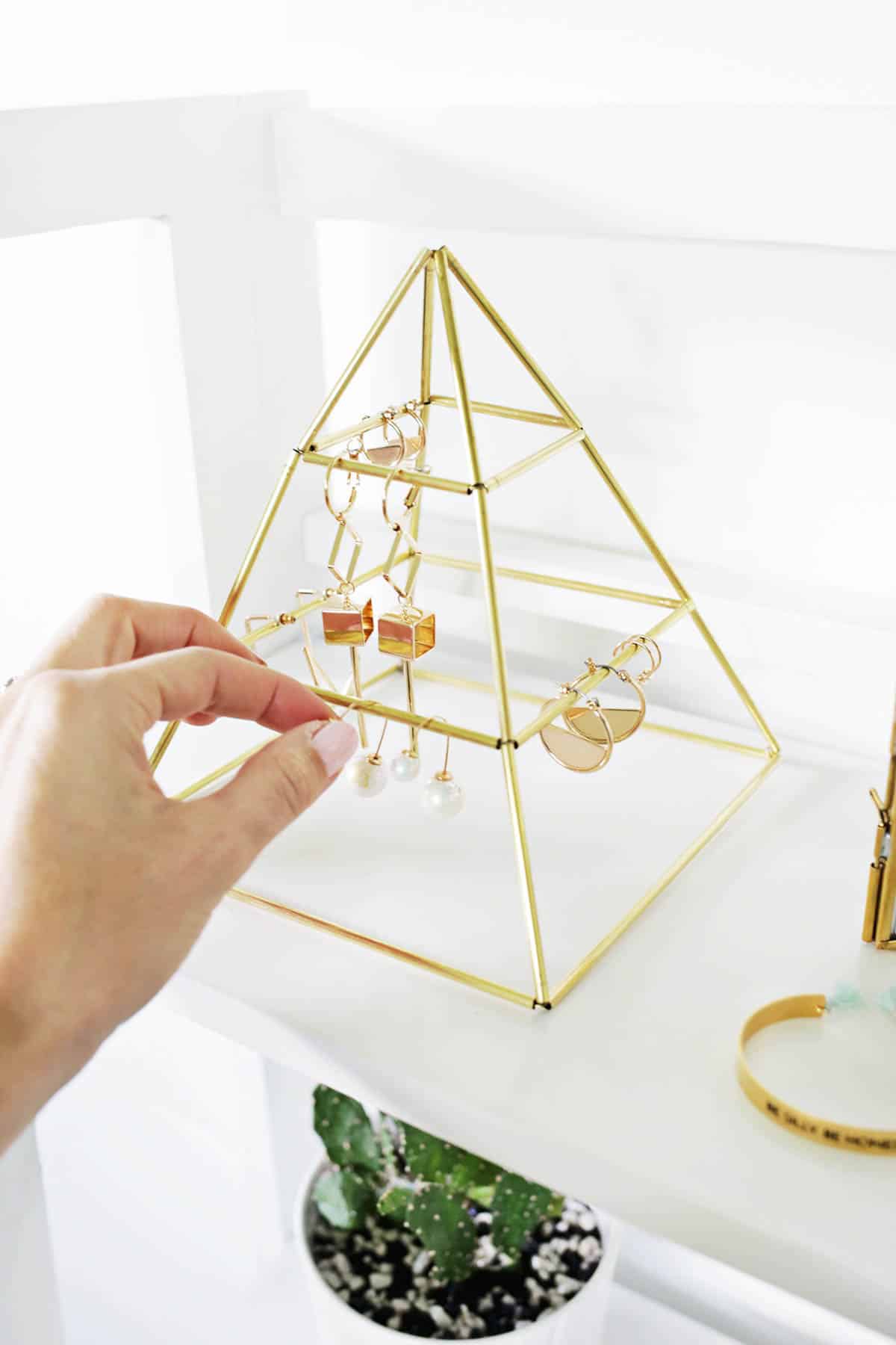 DIY pyramid made from brass tubes to hold earrings