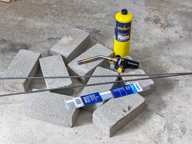 cement bricks and brazing equipment on garage floor