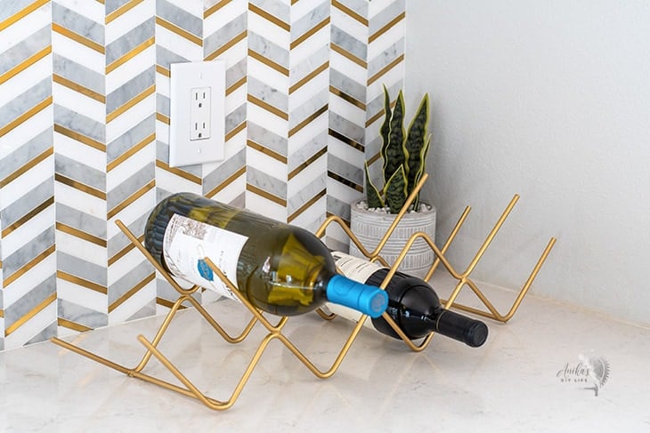 gold DIY metal wine rack on kitchen countertop