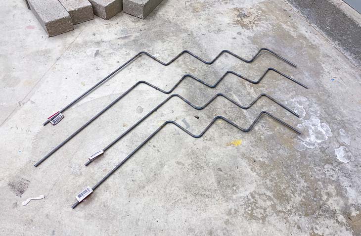 Steel rods bent using a blow torch