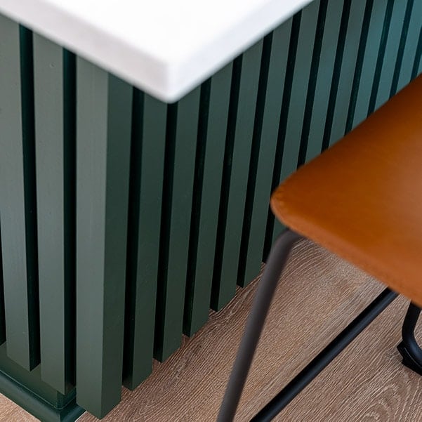 Add character to the plain back of a kitchen island using wood slat trim with this step-by-step tutorial & video. It's a quick 2 day project!