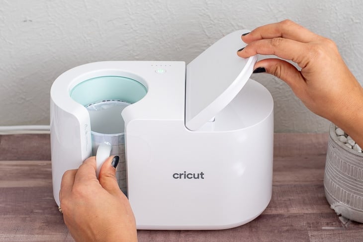 Woman adding Mug to the Cricut MugPress