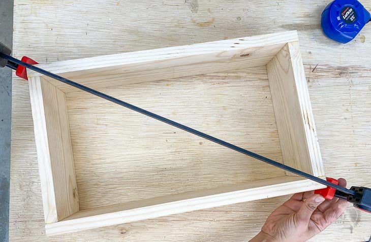 woman attaching clamps to correct for square