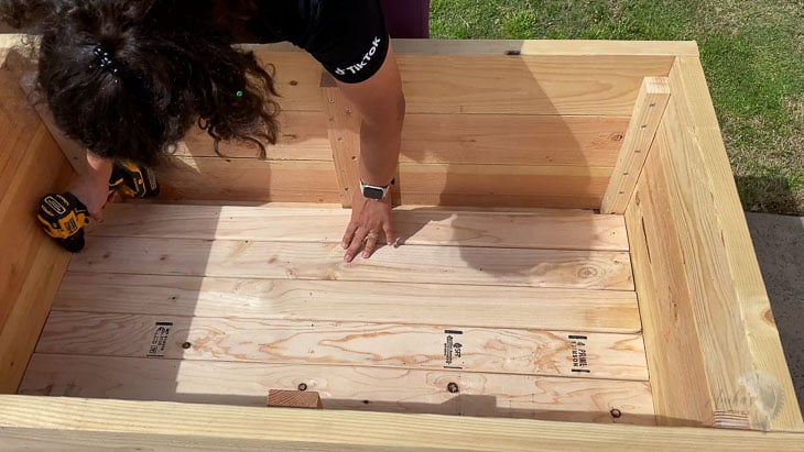 adding the 2x4 slats to the bottom of the DIY planter