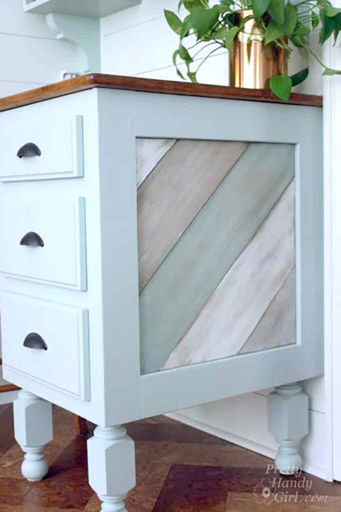 distressed wood panel on the side of a desk framed by wood trim