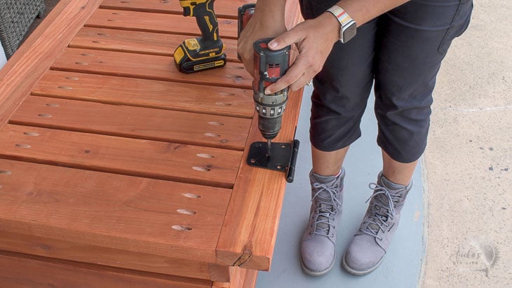 Attaching a hinge to the outdoor storage box for toys
