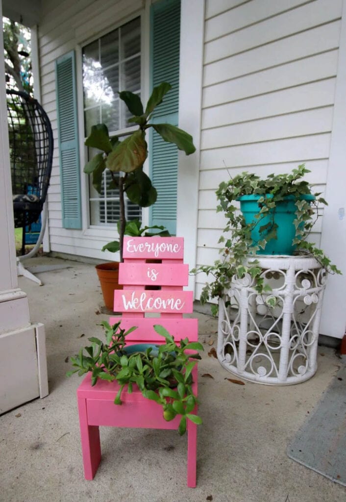 pink wooden planter shaped like a chair
