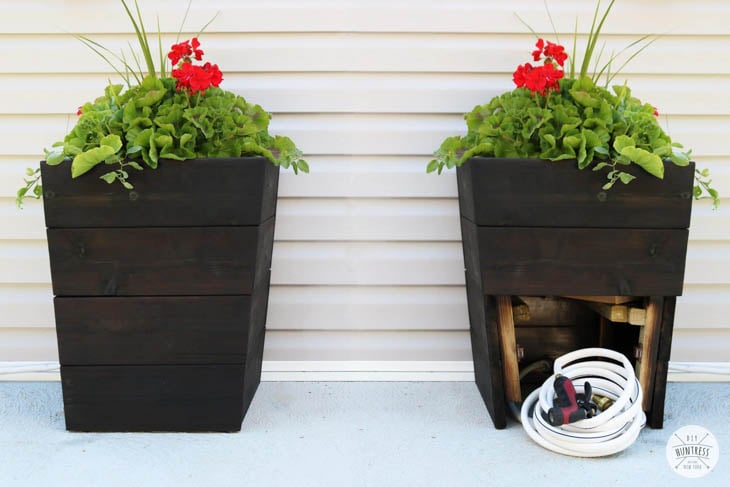 tapered wood planter boxes with garden hose storage in the bottom