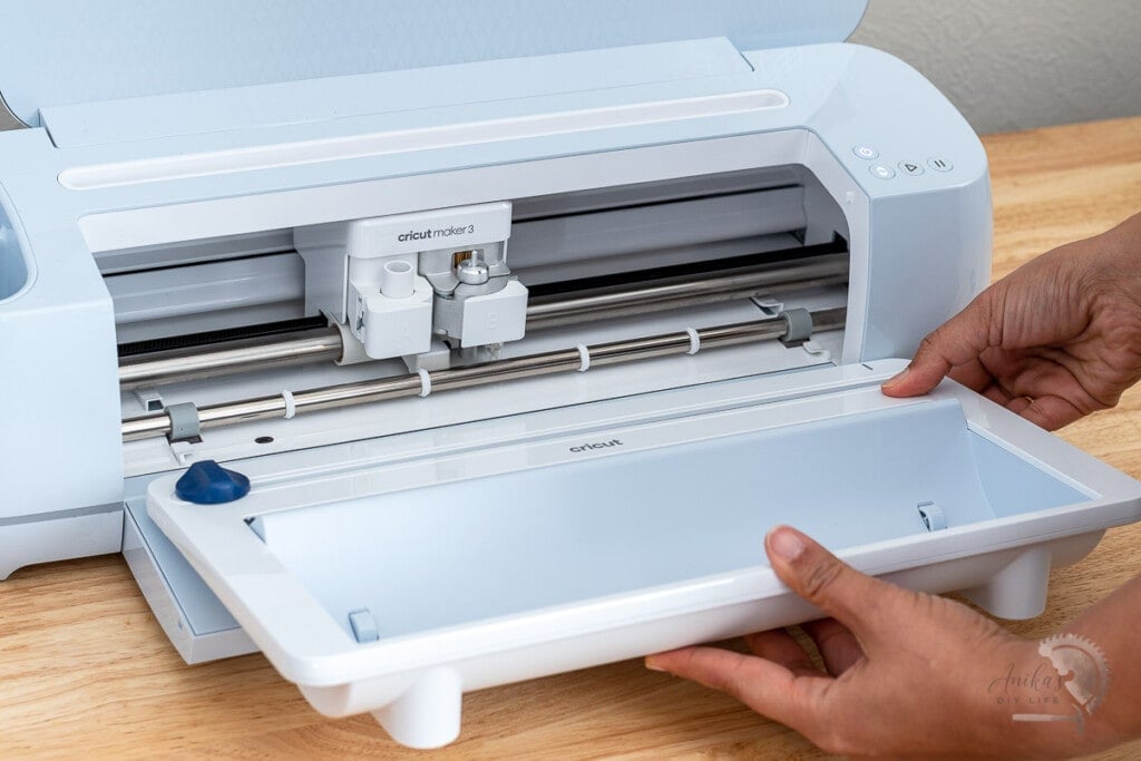 Woman attaching Smarl Vinyl Roll holder to a Cricut Maker 3