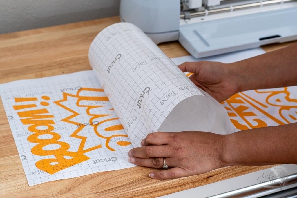Woman transferring design cut on Cricut Maker 3onto Transfer Tape