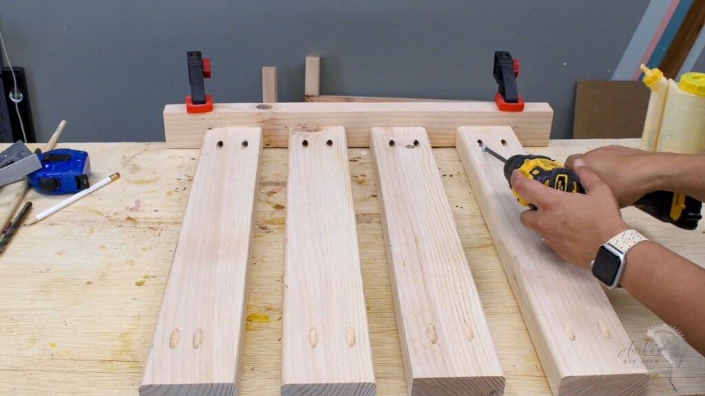 Building chair seat by attaching slats to the back of he chair with pocket hole screws.