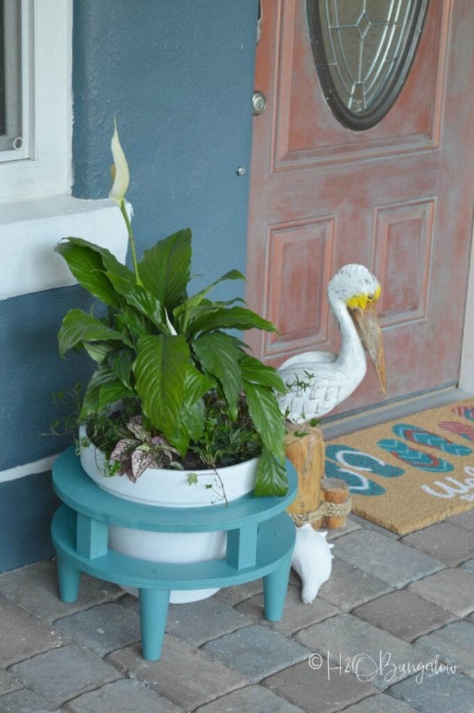 Round teal colored plant stand