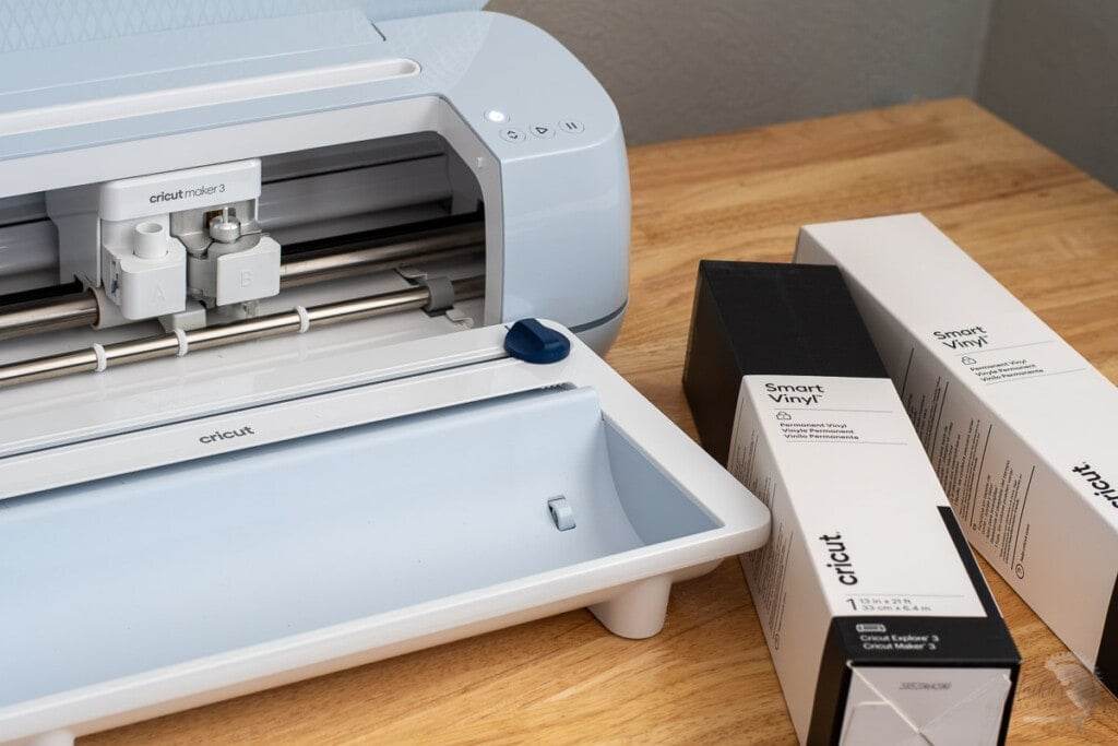 Cricut Maker 3 with vinyl rolls on the table