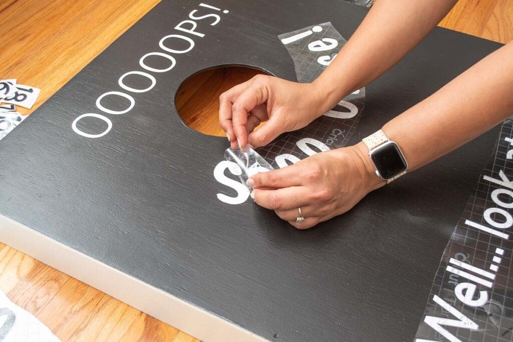 Woman transferring design onto the cornhole baords