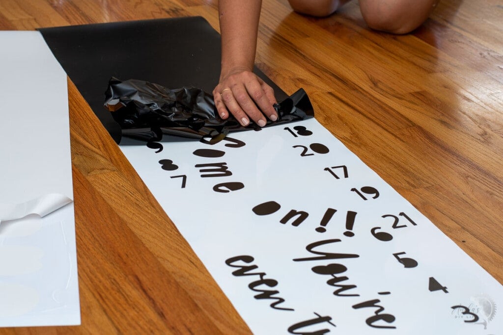 Woman removing vinyl cut on the cricut