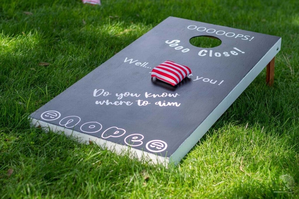 Black bean bag toss game in grass