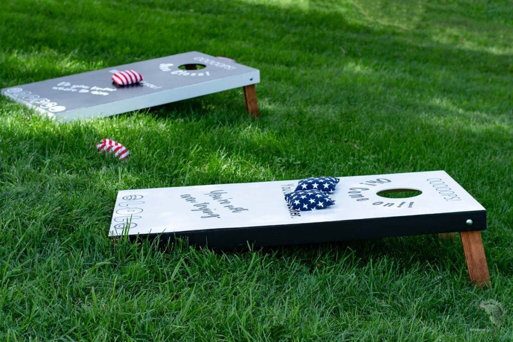 black and white cornhole boards in the grass