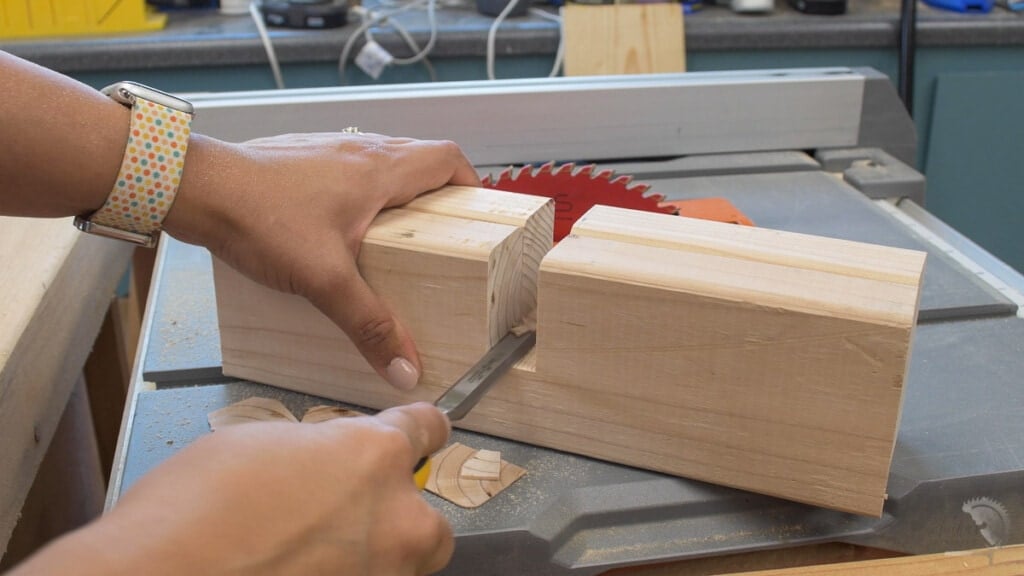 Cleaning out the slot on the 2x4 boards with a chisel